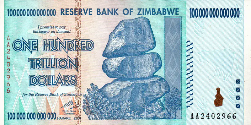 Front of a genuine 2008 Zimbabwe 100 trillion dollar note, serial AA2402966, with the Chiremba Balancing Rocks at center